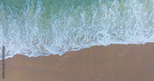 Beautiful sea summer landscape, Waves sea water surface High quality video Bird's eye view, Drone top view waves crashing on sand beach,Nature ocean sea beach background