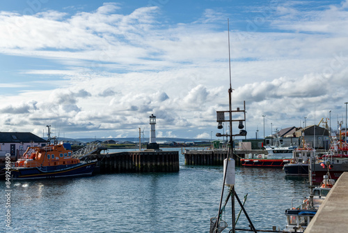 Scotland Kirkwall marina full of yachts with a lighthouse on an overcast afternoon 