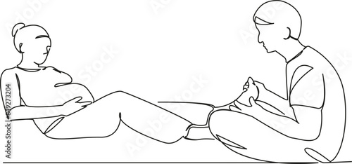 husband massages feet of pregnant wife