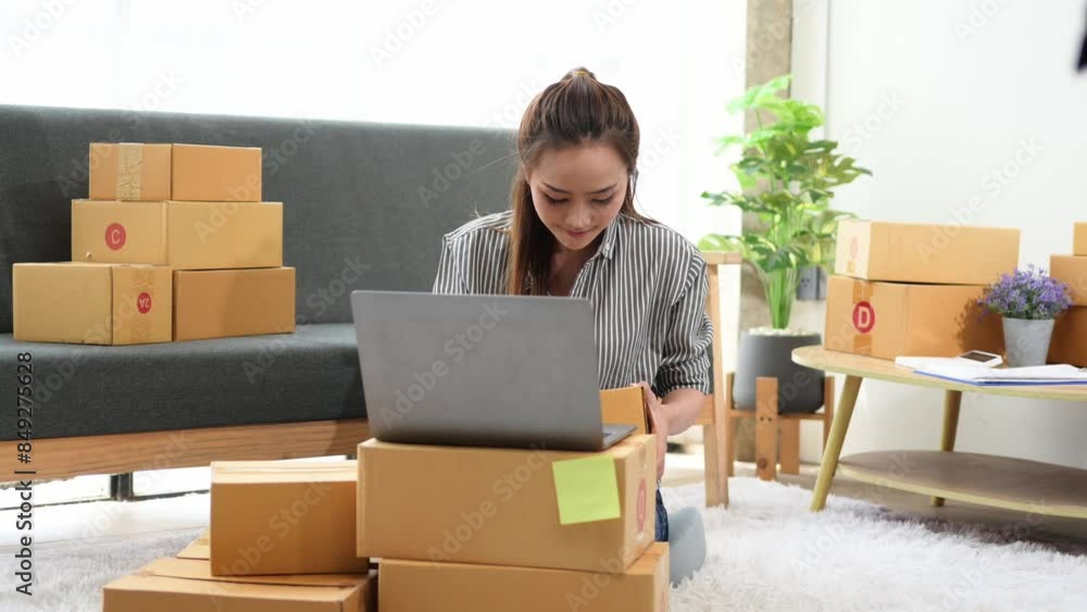 A woman is sitting on the floor in front of a pile of boxes A woman is sitting on the floor in front of a pile of boxes