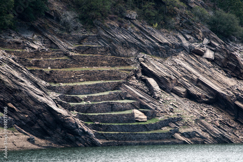 Ancient walls terracing slopes for cultivation on the Minho river photo