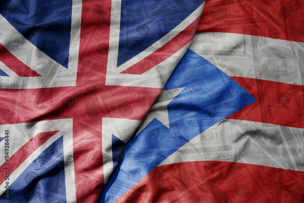 big waving colorful flag of puerto rico and national flag of great britain on the dollar money background. finance concept. big waving colorful flag of puerto rico and national flag of great britain on the dollar money background. finance concept.
