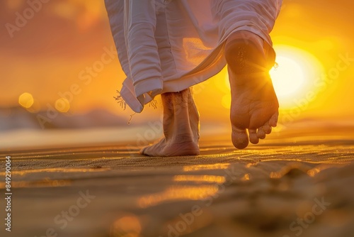 Close up low angle view of Jesus feet walking on sand