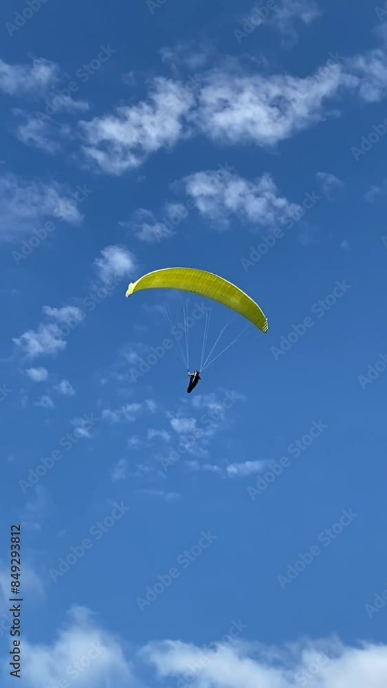 The paraglider flies over the sea. The view of a man on a paraglider flying over the horizon in a clear sky in summer. The concept of outdoor activities in summer. The paraglider flies over the sea. The view of a man on a paraglider flying over the horizon in a clear sky in summer. The concept of outdoor activities in summer.