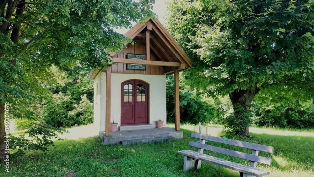 Small chapel surrounded by trees in the light Small chapel surrounded by trees in the light