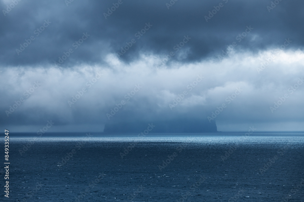 Koltur Island Hidden by Storm Clouds in the Atlantic Ocean. Faroe islands, Denmark. Landscape photography Koltur Island Hidden by Storm Clouds in the Atlantic Ocean. Faroe islands, Denmark. Landscape photography