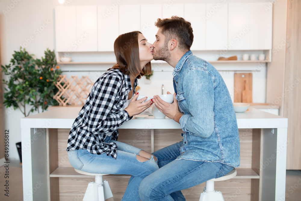 young happy man and woman in kitchen, breakfast, couple together in morning young happy man and woman in kitchen, breakfast, couple together in morning