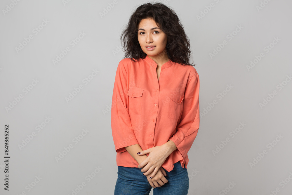 portrait of young attractive brunette woman in orange shirt, curly hair, shy, smiling, happy, natural look, summer style, fashion trend, looking in camera, mixed race, isolated portrait of young attractive brunette woman in orange shirt, curly hair, shy, smiling, happy, natural look, summer style, fashion trend, looking in camera, mixed race, isolated