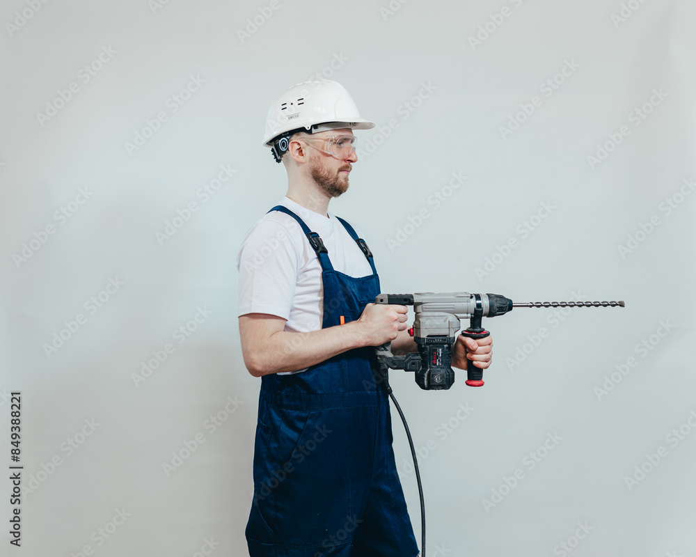 worker with a drill side view worker with a drill side view
