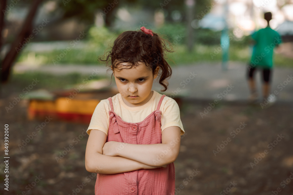 Upset lonely bullied little kid girl looking away feels abandoned abused, sad alone preschool child in kindergarten or playground Upset lonely bullied little kid girl looking away feels abandoned abused, sad alone preschool child in kindergarten or playground