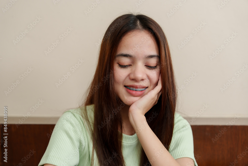 Content female with gentle smile holds tablet, her enjoyment reflected in homely atmosphere. Young woman beams while holding device, radiating satisfaction in a comfortable indoor setting. Content female with gentle smile holds tablet, her enjoyment reflected in homely atmosphere. Young woman beams while holding device, radiating satisfaction in a comfortable indoor setting.