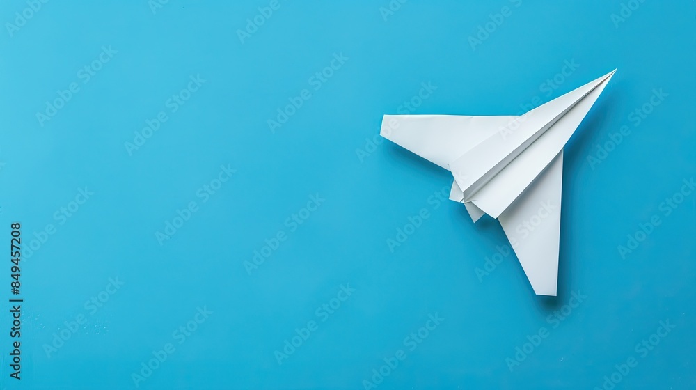 White Paper Airplane on a Blue Background White Paper Airplane on a Blue Background