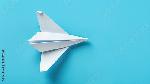 White Paper Airplane on a Blue Background