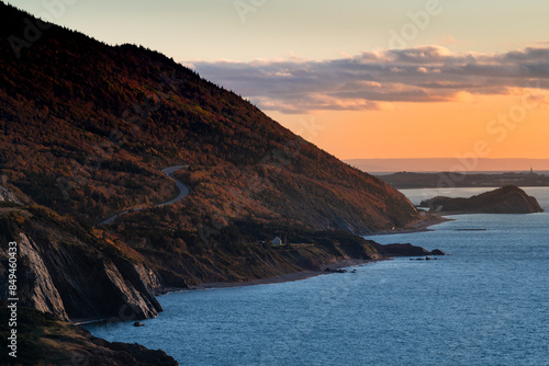Scenic view of the coastline with the sea and mountains at the Cape Breton Highlands National Park, in Nova Scotia, Canada, at sunset.