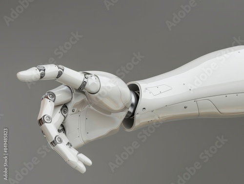Robotic hand pointing to side with copy space, white artificial humanoid hand making the pointing gesture isolated on gray background.