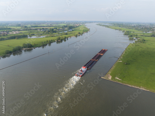 Obraz na plátně Aerial view on the Waal river, Motor tanker inland shipping barge vessel