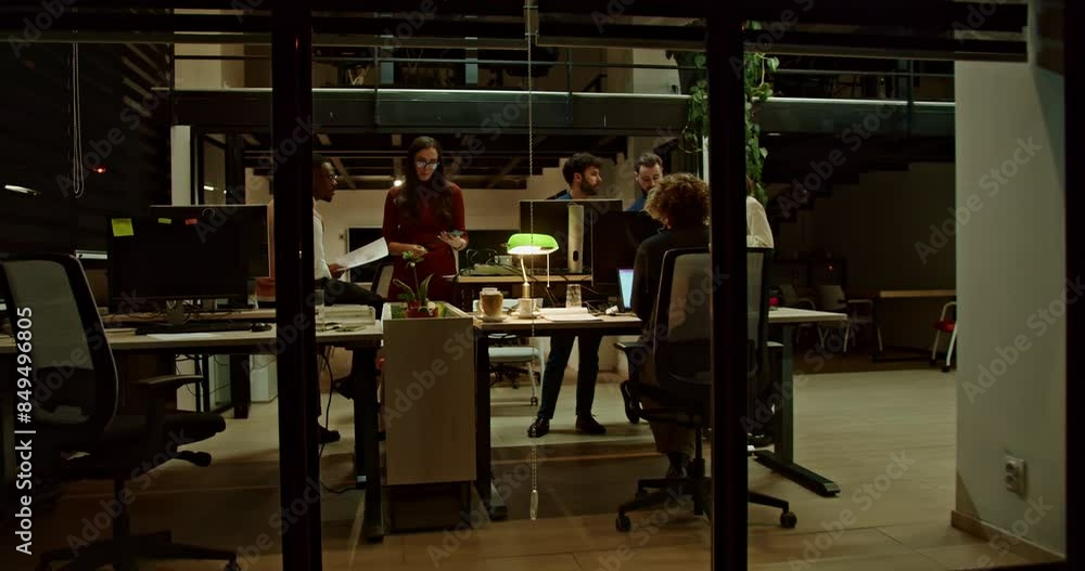 A multiethnic group of business employees collaborates on a project late at night in a contemporary office setting, illuminated by desk lamps, showcasing their commitment and teamwork. A multiethnic group of business employees collaborates on a project late at night in a contemporary office setting, illuminated by desk lamps, showcasing their commitment and teamwork.