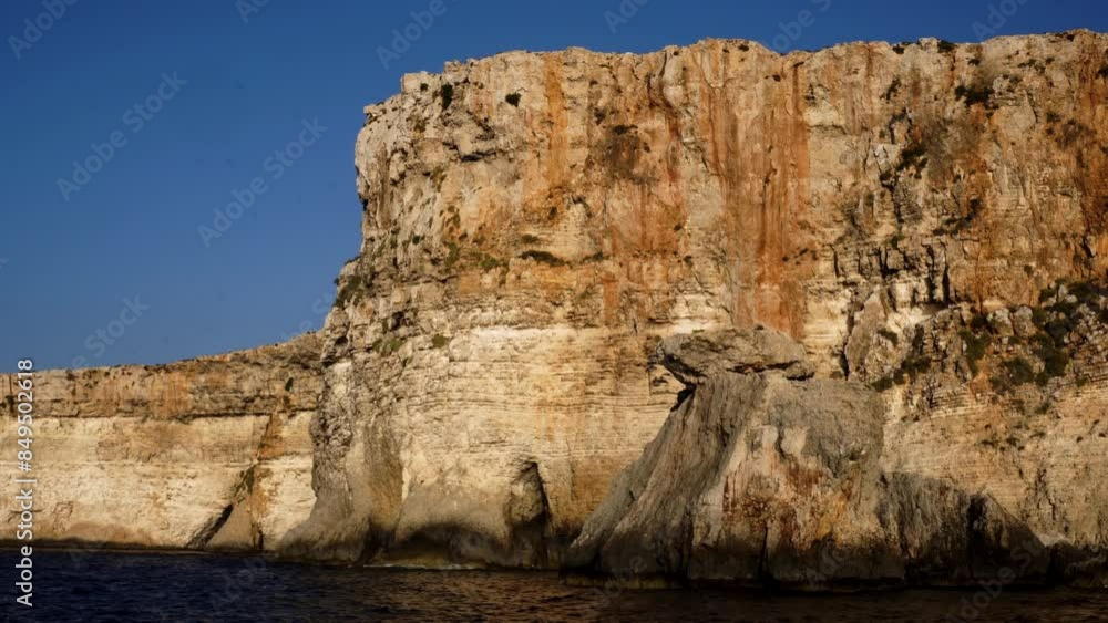 Aerial view of the crystal clear turquoise water of Blue Lagoon on the island of Comino. picturesque beautiful cliffs. at sunset. Malta, Comino. blue sea, ocean, vacation, summer