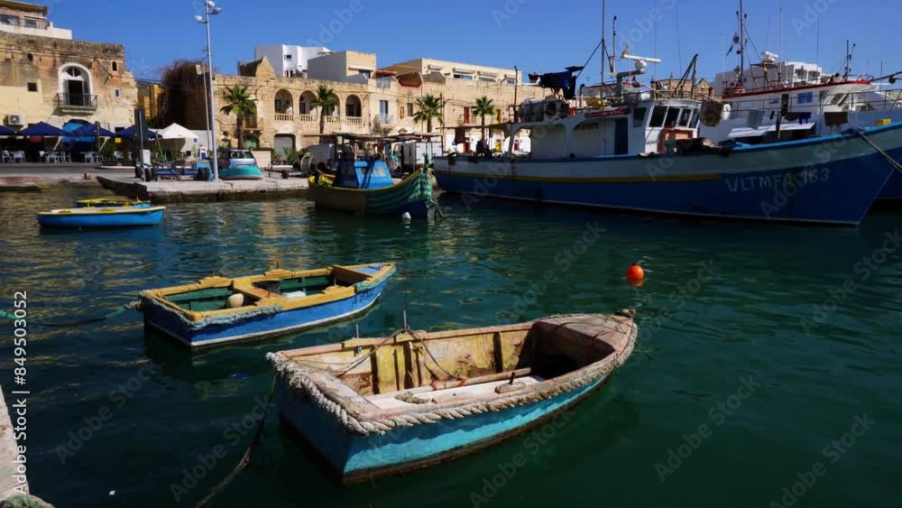 Marsaxlokk harbour with Traditional Luzzu fishing boats, a beautiful Mediterranean town on a sunny day. Old Colorful Boats. Malta Marsaxlokk harbour with Traditional Luzzu fishing boats, a beautiful Mediterranean town on a sunny day. Old Colorful Boats. Malta