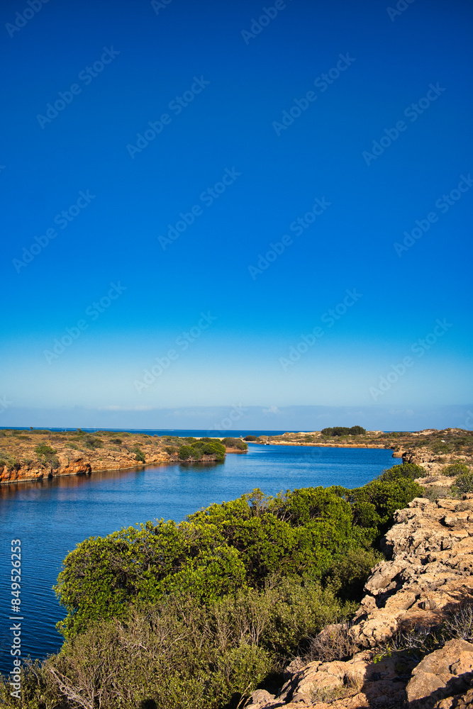 The mouth of Yardie Creek in Cape Range National Park, Western Australia. Rocks with stunted outback vegetation, in the distance the Indian Ocean
The mouth of Yardie Creek in Cape Range National Park, Western Australia. Rocks with stunted outback vegetation, in the distance the Indian Ocean
