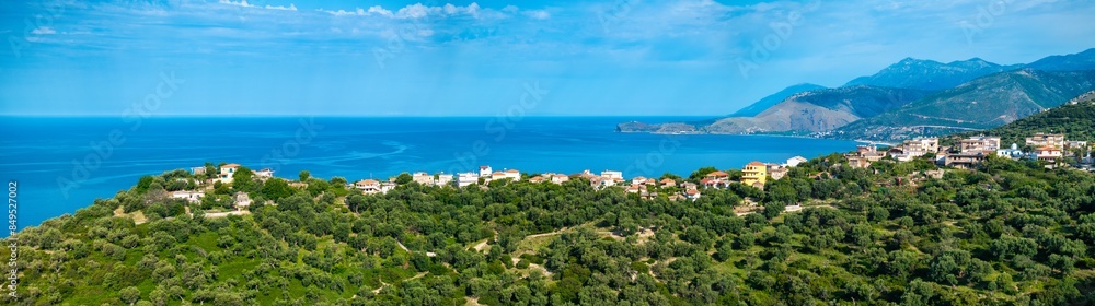Panoramic image of Piqeras, a small village in the Albanian Riviera showing the beautiful landscape and Ionian sea. Panoramic image of Piqeras, a small village in the Albanian Riviera showing the beautiful landscape and Ionian sea.