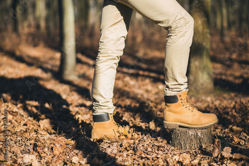 young hipster man traveling with backpack in spring autumn forest