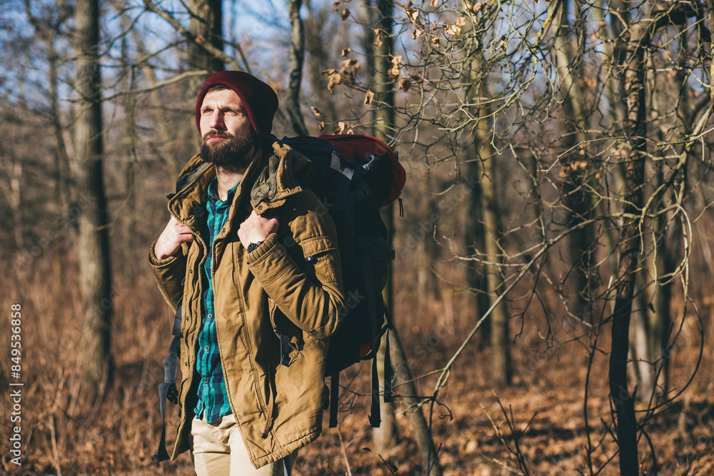 young hipster man traveling with backpack in spring autumn forest young hipster man traveling with backpack in spring autumn forest