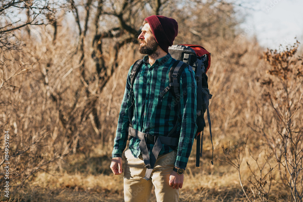 young hipster man traveling with backpack in spring autumn forest young hipster man traveling with backpack in spring autumn forest
