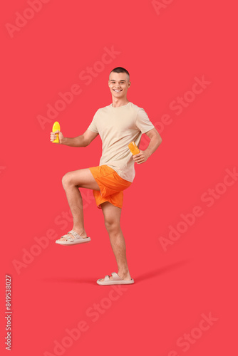 Happy young man with bottle...