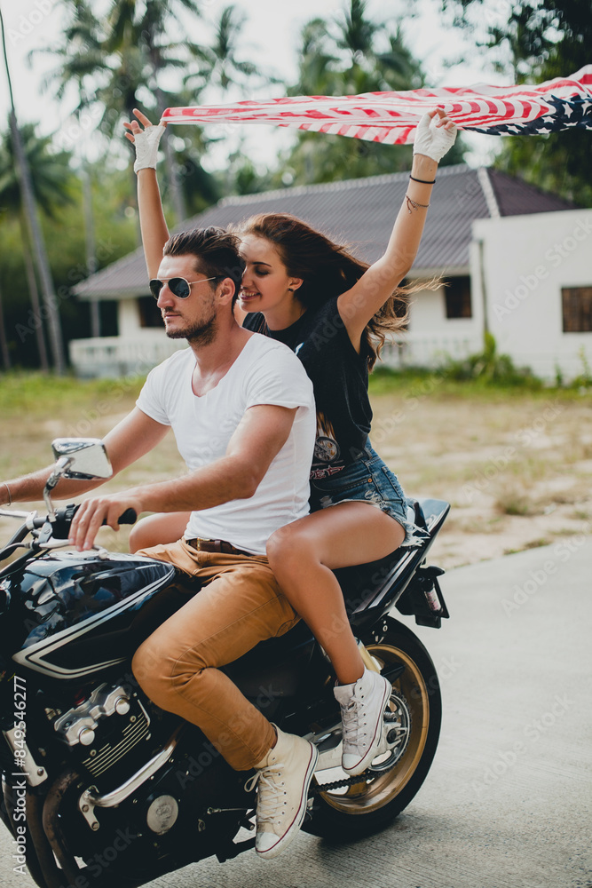 Obraz premium young couple in love, riding a motorcycle, hug, passion, free spirit, american flag