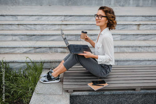 attractive business woman working outside on laptop © mary_markevich