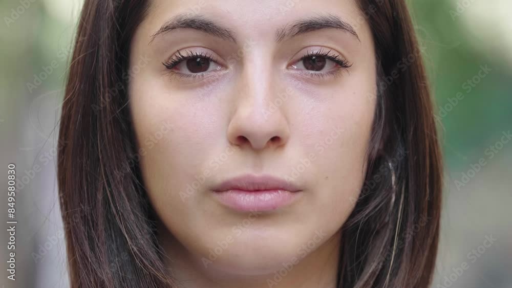 Extreme close-up of young woman looking very serious Extreme close-up of young woman looking very serious