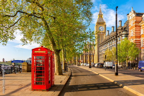 Red telephone boxes on Victoria embankment and Big Ben tower, London, UK