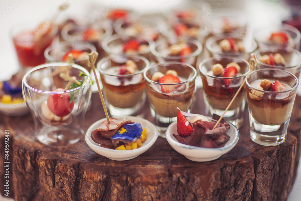 Different canapes with smoked meat, vegetables, cheese. Breakfast buffet table with a variety of snacks. Buffet served table with snacks,fruits,canape,sweets and appetizers. snacks in shot glasses Different canapes with smoked meat, vegetables, cheese. Breakfast buffet table with a variety of snacks. Buffet served table with snacks,fruits,canape,sweets and appetizers. snacks in shot glasses