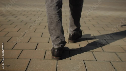 A man walks up sunlit stairs, symbolizing determination, progress, achievement in urban setting photo