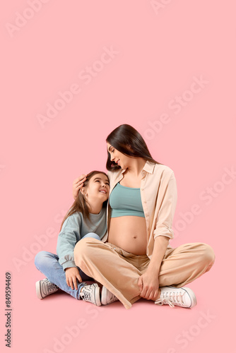 Little girl with her pregna...