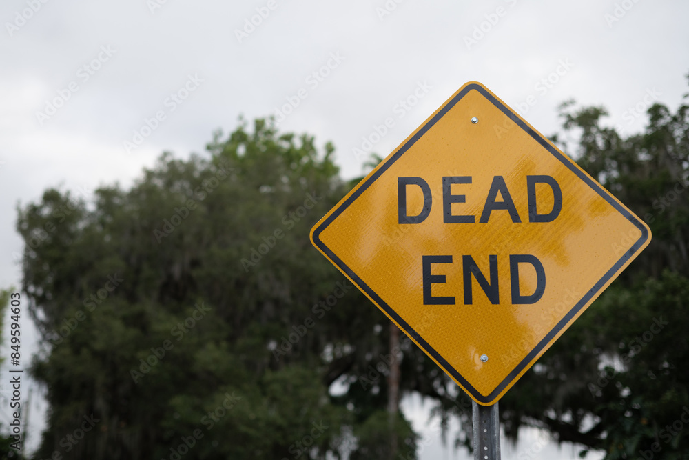 DEAD END diamond yellow and black old rustic sign, close up with copy space on right DEAD END diamond yellow and black old rustic sign, close up with copy space on right