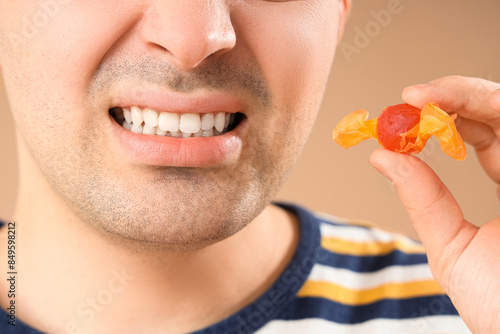 Young man with candy suffer...