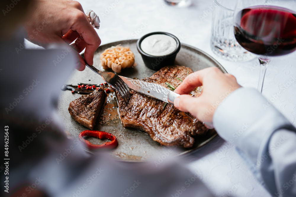 Beef steak served with red wine for dinner at a restaurant.