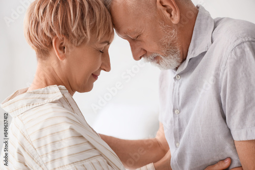 Mature couple hugging in clinic, closeup