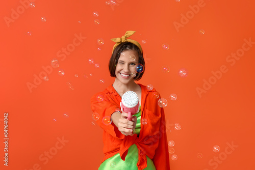 Happy teenage girl blowing ...