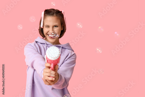 Teenage girl with soap bubb...