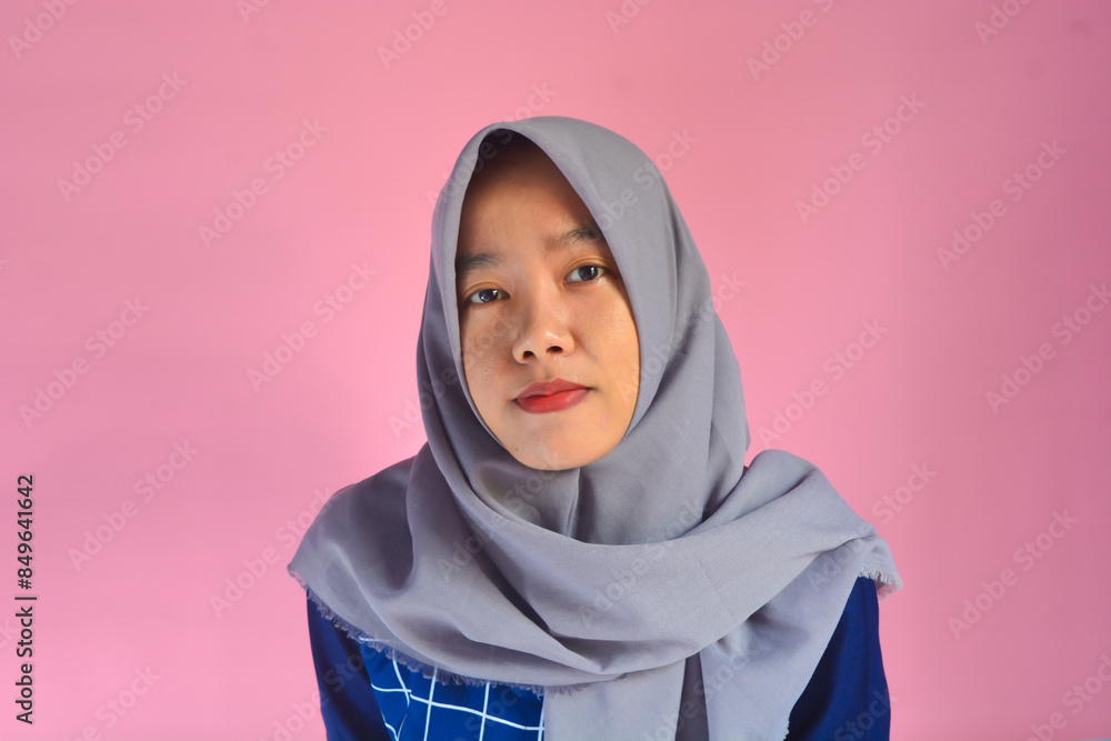 A asian woman standing confidently and smiling at the camera A asian woman standing confidently and smiling at the camera