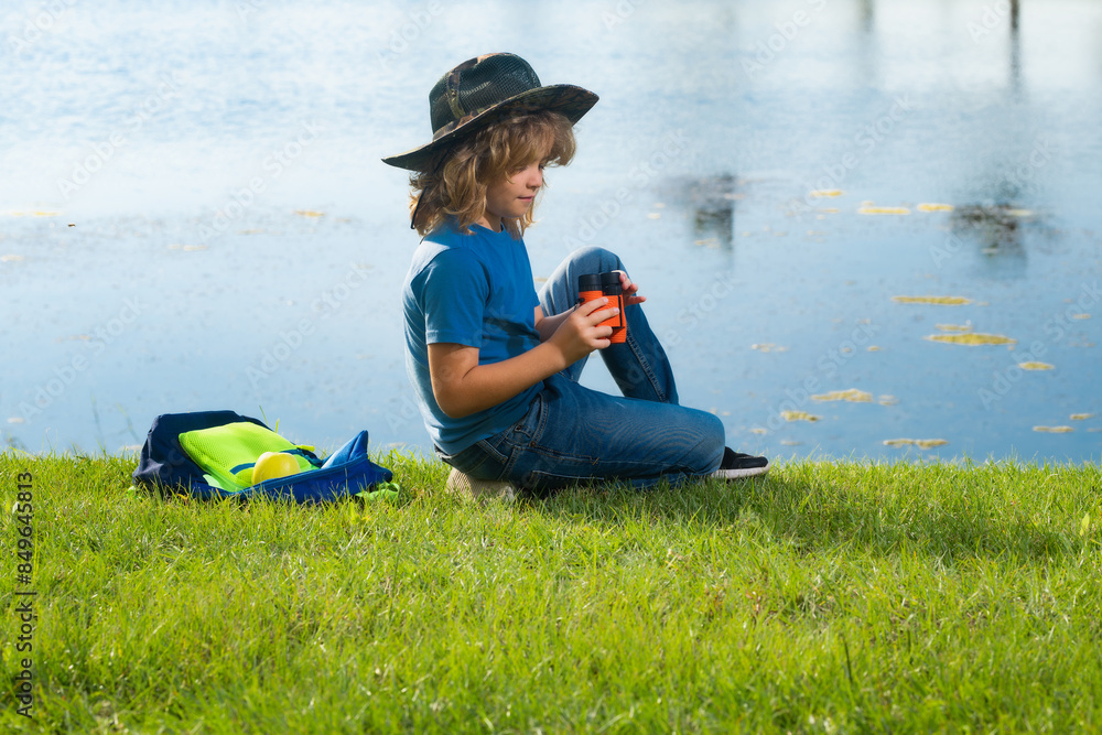 Travel and adventure concept. Little child boy tourist explorer with binoculars on nature. Discovery, exploring and education. Travel and adventure concept. Little child boy tourist explorer with binoculars on nature. Discovery, exploring and education.
