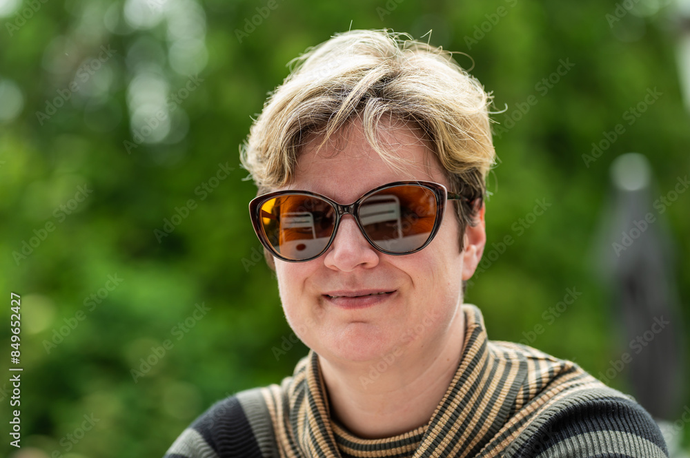 Portrait of a 38 yo white woman with a green bokeh background, Belgium Portrait of a 38 yo white woman with a green bokeh background, Belgium