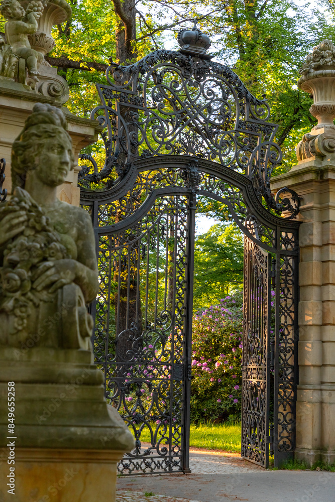 Fototapeta premium gate to the park in the town of Walbrzych at sunset in spring