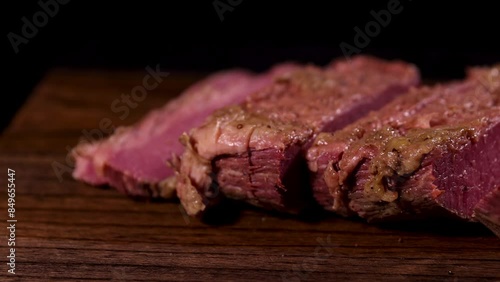 Succulent, mediumrare steak slices on a rustic wooden board, ideal for a gourmet dining experience photo