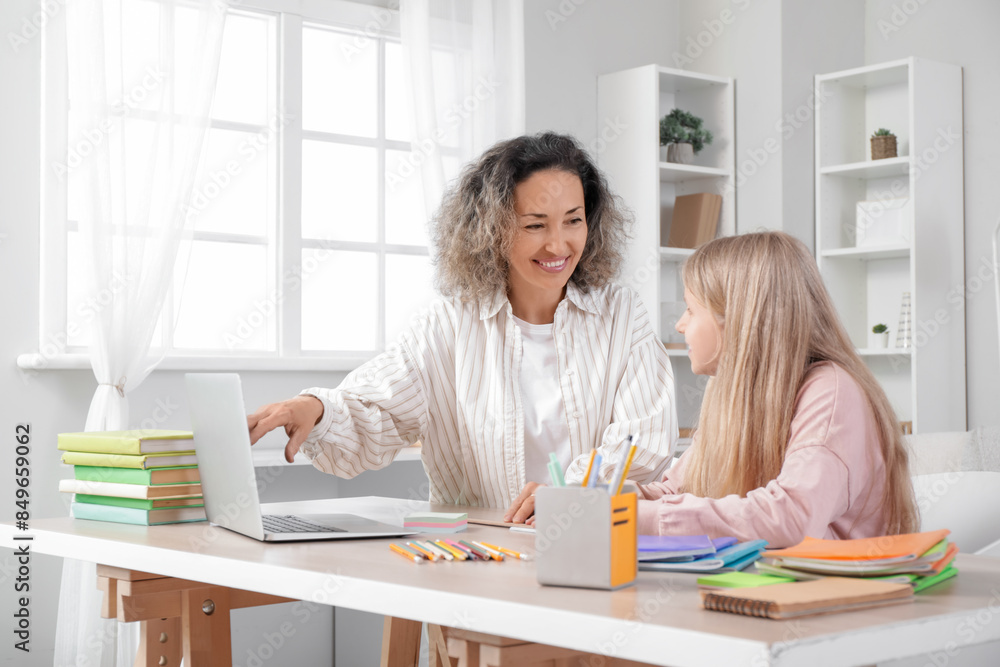 Little girl studying Math with tutor at home Little girl studying Math with tutor at home