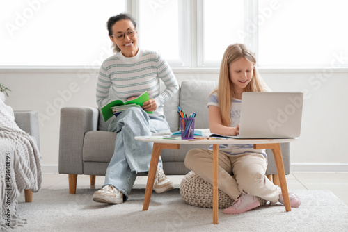 Little girl with laptop and...