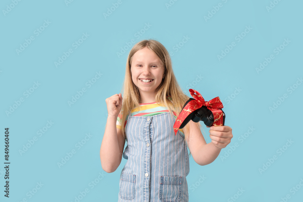 Little girl with gift on blue background Little girl with gift on blue background